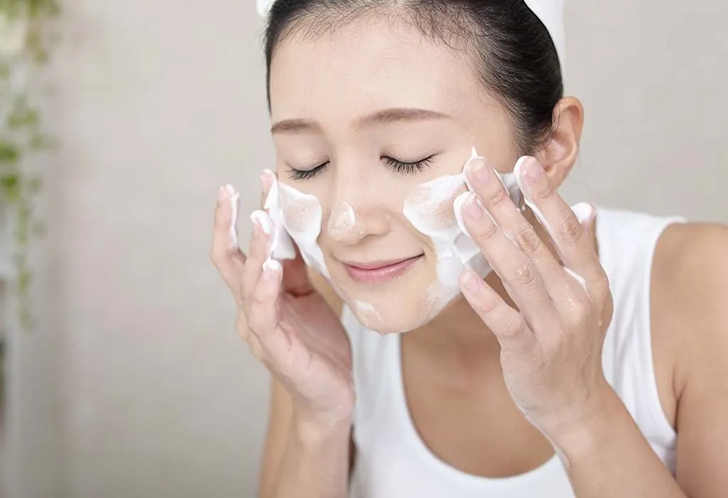 Woman using whitening skin face wash for clear, radiant skin