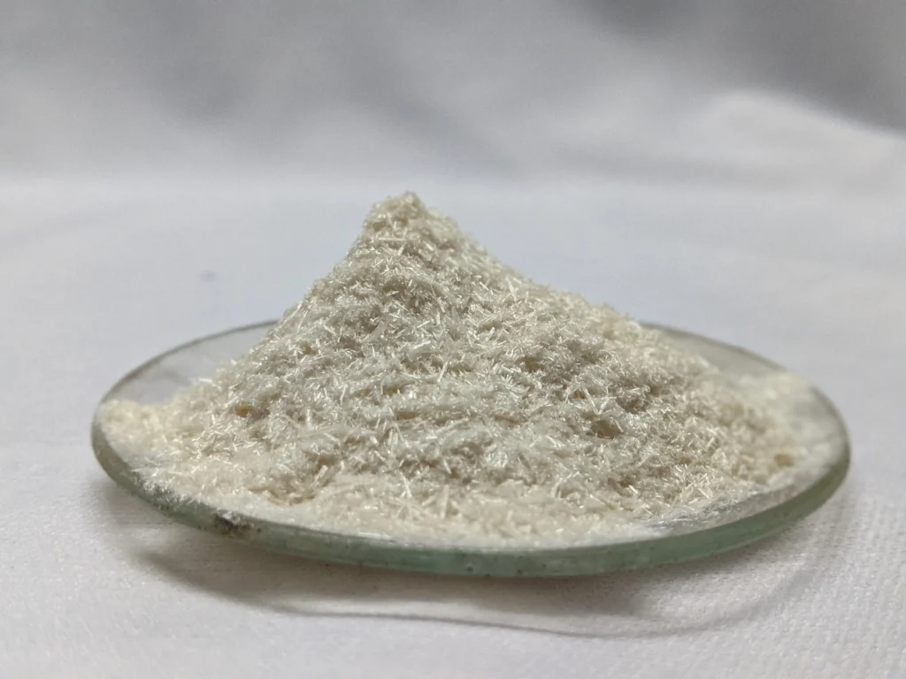 Kojic acid powder or source ingredient representing its skin-brightening and spot-reducing benefits.